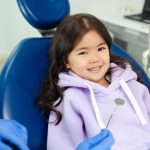 Smiling young girl in a dental chair at a children's check-up